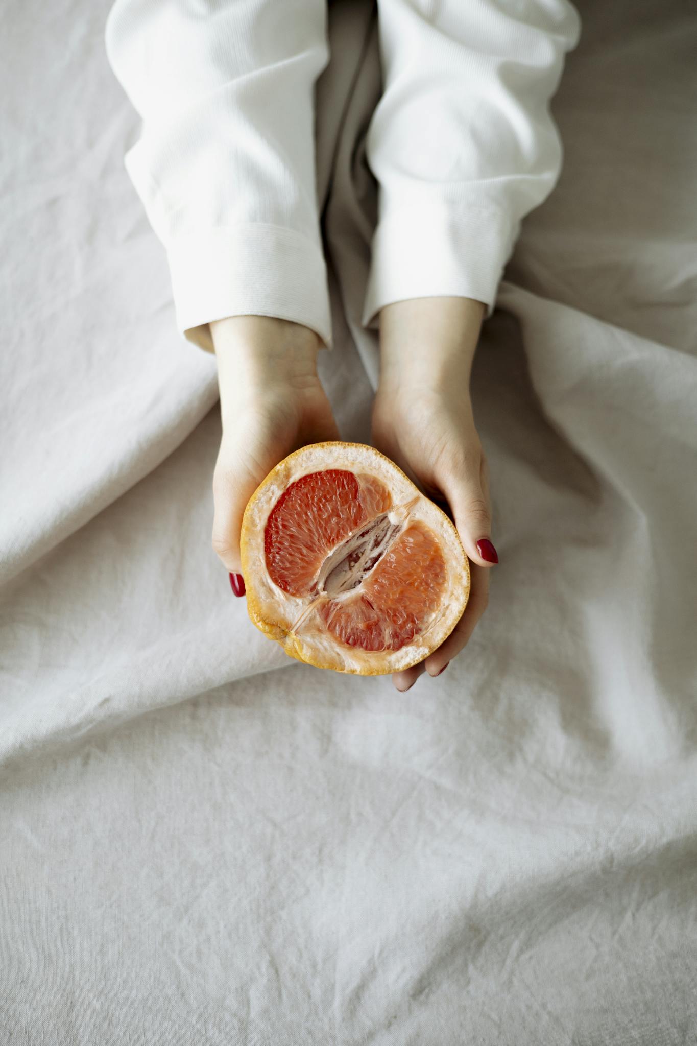 Person Holding Sliced Orange Fruit